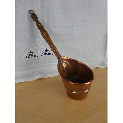 540 - An antique copper handled pot.