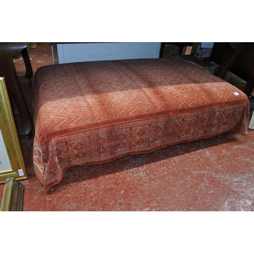 550 - A large upholstered footstool, measuring 33