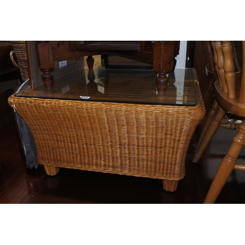 554 - A large wicker coffee table with glass top.