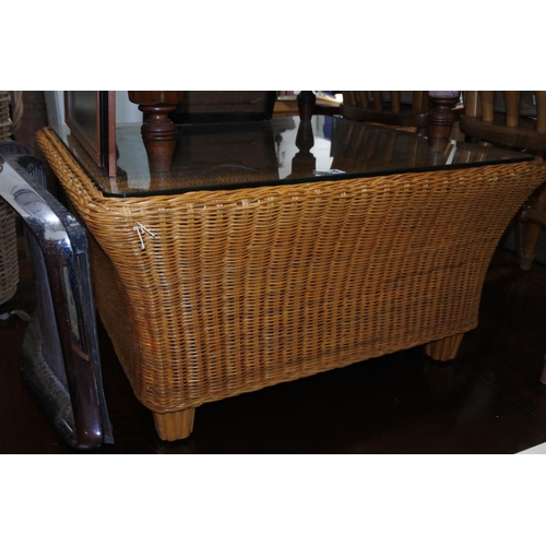 554 - A large wicker coffee table with glass top.