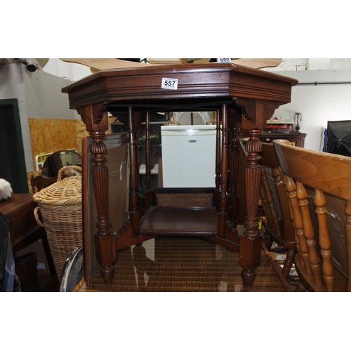 557 - An antique mahogany hexagonal table with undershelf.