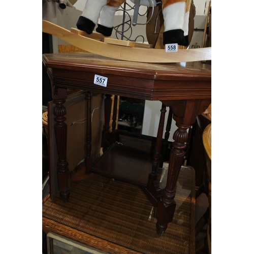 557 - An antique mahogany hexagonal table with undershelf.