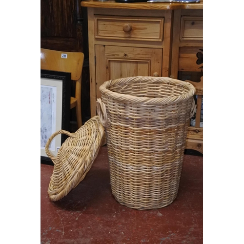 563 - A lidded wicker laundry bin.