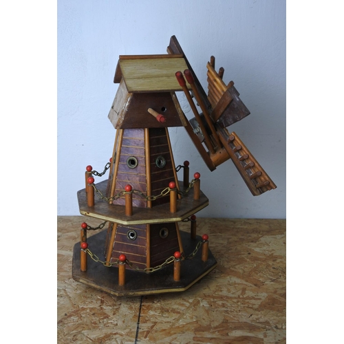 579 - A wooden windmill. (a/f)