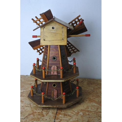 579 - A wooden windmill. (a/f)