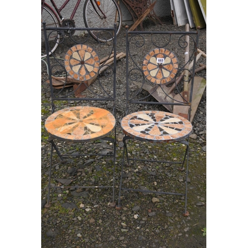 665 - A pair of decorative folding garden chairs.