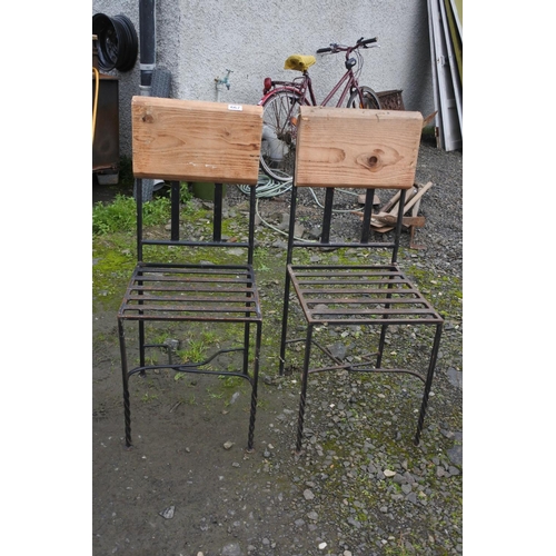 667 - A pair of metal framed garden chairs with wooden backs.