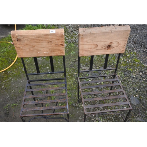 667 - A pair of metal framed garden chairs with wooden backs.