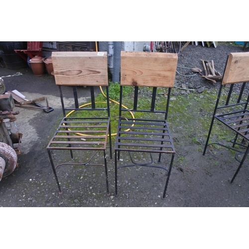 669 - A pair of metal framed garden chairs with wooden backs.