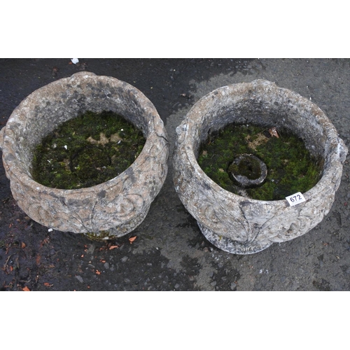 672 - A pair of large concrete garden planters.