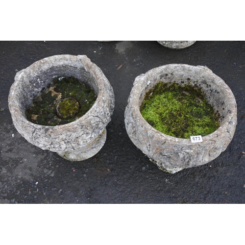 673 - A pair of large concrete garden planters.