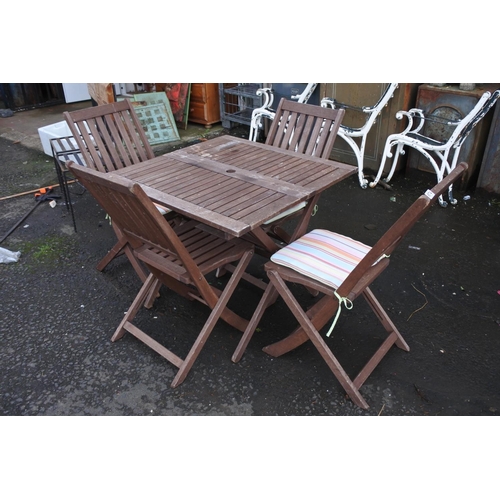 674 - A wooden garden table and four chair set.