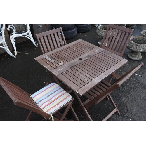 674 - A wooden garden table and four chair set.