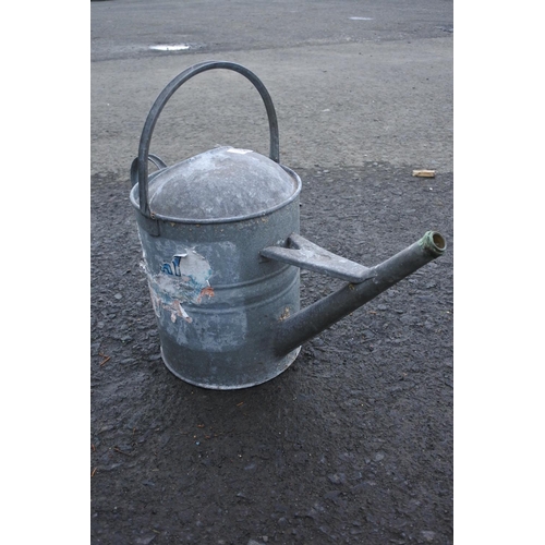 676 - A galvanised watering can.