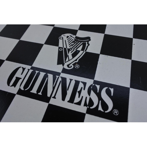 682 - A Guinness chess board in a pine wooden frame.