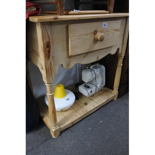 683 - A pine side table with drawer and undershelf.