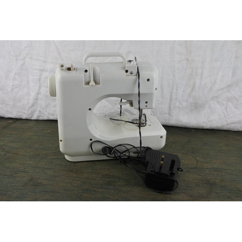 685 - A small Poweran electric sewing machine.