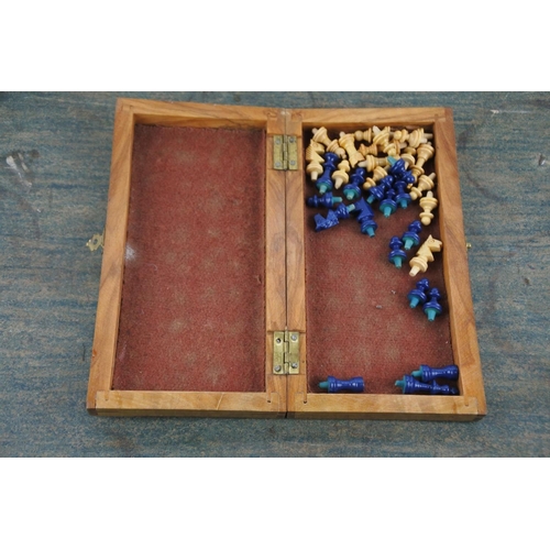 725 - A miniature wooden cased chess set.