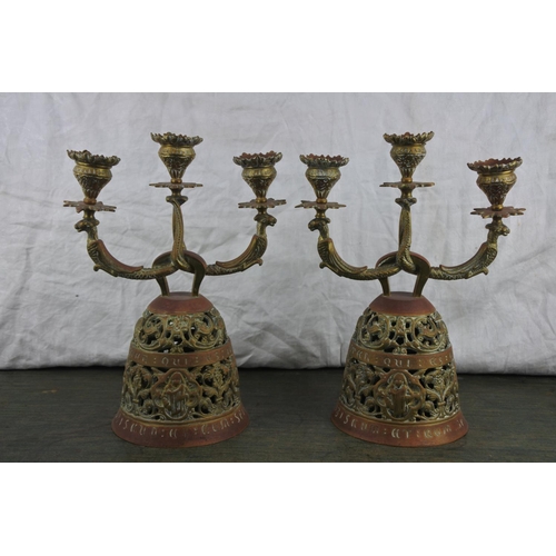 727 - An unusual pair of ornate brass 'Sanctuary'  candlesticks.