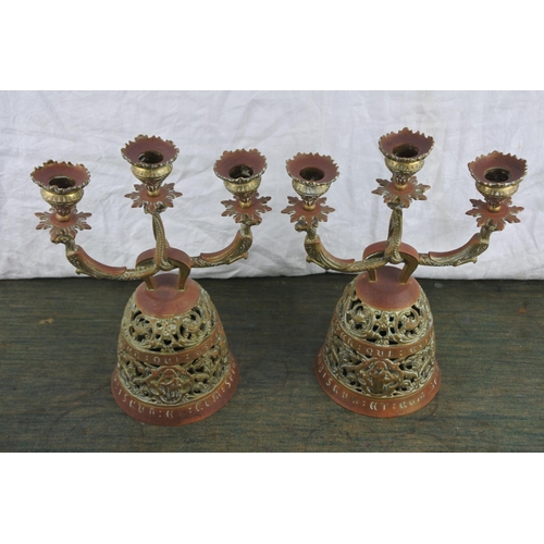 727 - An unusual pair of ornate brass 'Sanctuary'  candlesticks.