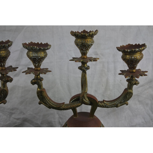 727 - An unusual pair of ornate brass 'Sanctuary'  candlesticks.