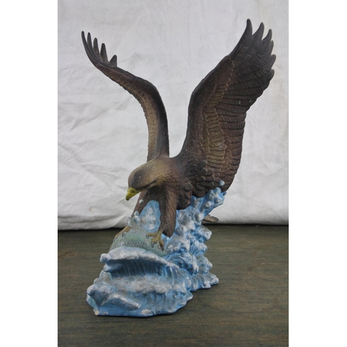 729 - An ceramic figure of an eagle.