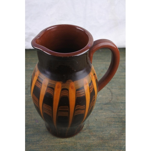 731 - A vintage studio pottery terracotta glazed jug.