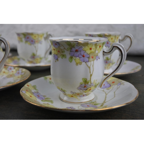 735 - A 12 piece floral pattern coffee set.