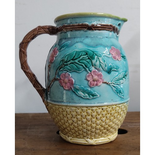 693 - A stunning antique ceramic jug with floral detail.