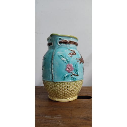 693 - A stunning antique ceramic jug with floral detail.