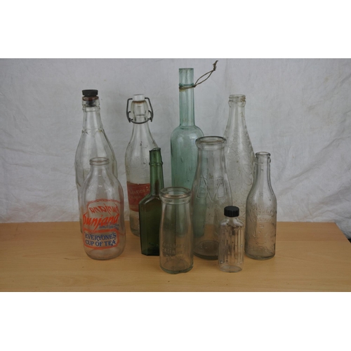 26 - A lot of vintage glass bottles to include Punjana, Corry, Belfast, Dhu Varren Dairies Ltd and more.