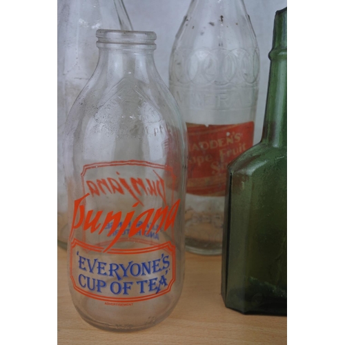 26 - A lot of vintage glass bottles to include Punjana, Corry, Belfast, Dhu Varren Dairies Ltd and more.