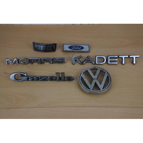 9 - A collection of car badges to include VW, Kadett, Gazelle, Morris and more.