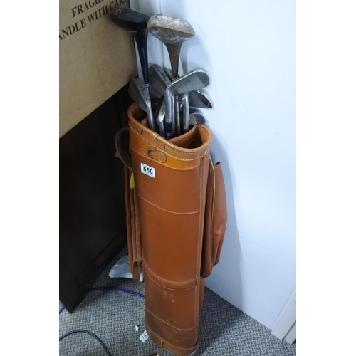 550 - A vintage bag of golf clubs and including some clubs.