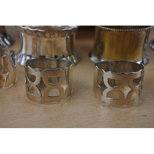 561 - A collection of silver plated napkin rings and dish.