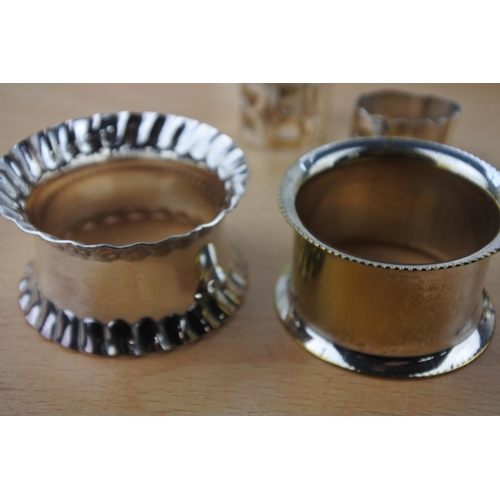 561 - A collection of silver plated napkin rings and dish.