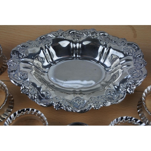 561 - A collection of silver plated napkin rings and dish.