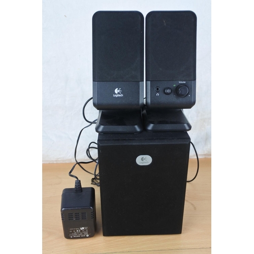 587 - A boxed Gigaworks T40 Series II speaker box and a set of Logitech speakers .