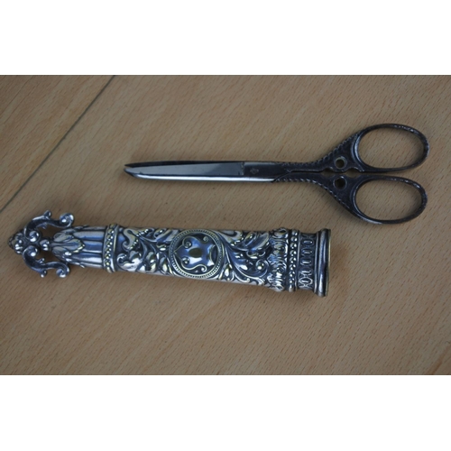 594 - A stunning Victorian silver plate decorative scissors and sheath.