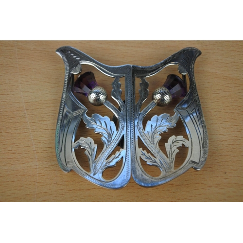599 - A silver plated buckle with thistle detail.