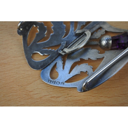 599 - A silver plated buckle with thistle detail.
