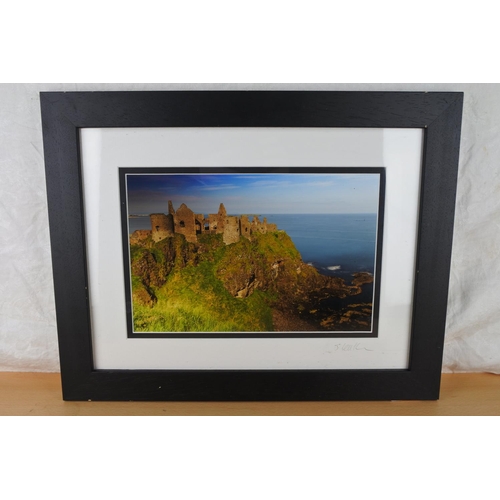 605 - A framed photograph of Dunluce Castle by Jonathan Leathem.
