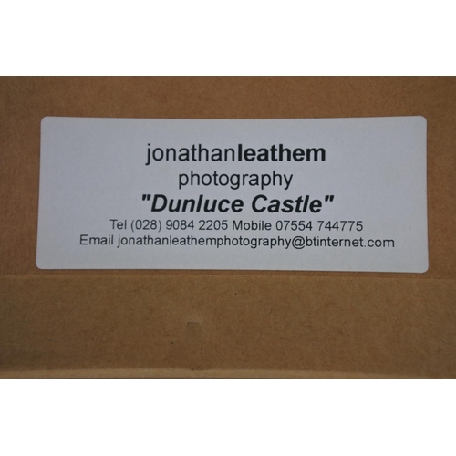 605 - A framed photograph of Dunluce Castle by Jonathan Leathem.