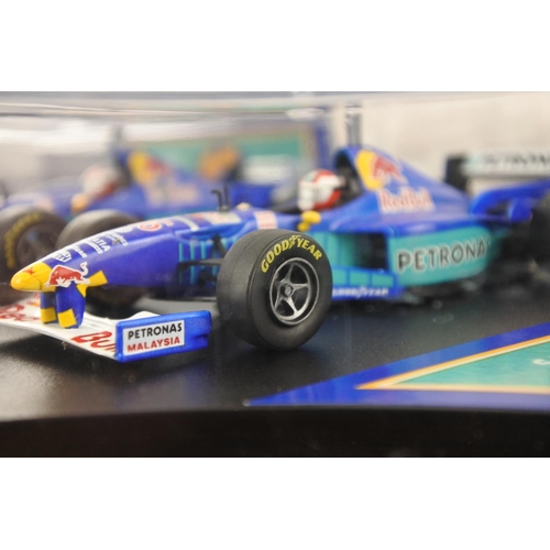 36 - Two cased Red Bull Sauber Petronas 1997 Formula One cars, racing drivers Johnny Herbert and Nicola L... 