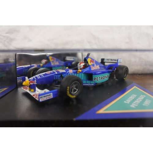 42 - Two cased Red Bull Sauber Petronas 1997 Formula One cars, racing drivers Johnny Herbert and Nicola L... 