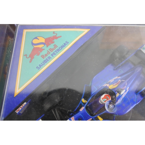 54 - A cased Red Bull Sauber Petronas 1997 Formula One car, racing driver Johnny Herbert and a cased Vite... 