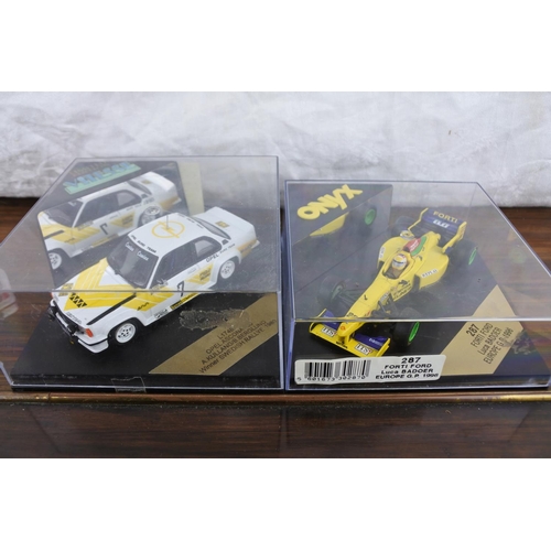 57 - A cased Vitesse limited edition L174B opel Ascona 400 and a cased Onyx 287 Forti Ford Luca Badoer.