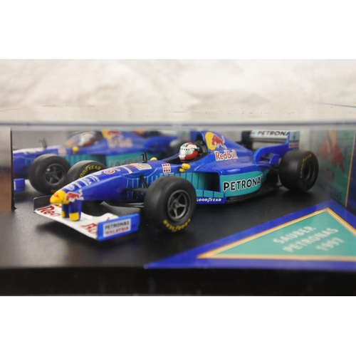 7 - Two cased Red Bull Sauber Petronas 1997 Formula One cars, racing drivers Johnny Herbert and Nicola L... 