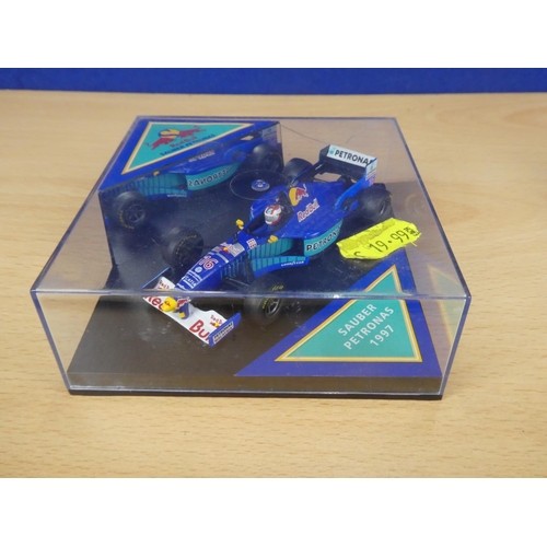 131 - A cased Red Bull Sauber Petronas 1997 Formula One cars, racing driver Johnny Herbert and a cased Ony... 