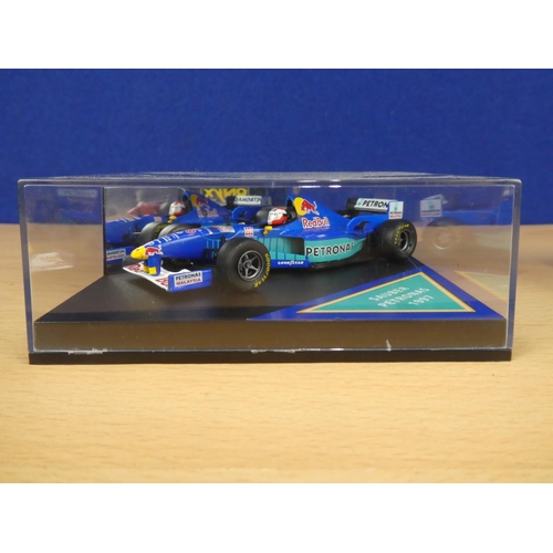 134 - A cased Red Bull Sauber Petronas 1997 Formula One cars, racing driver Johnny Herbert and a cased Ony... 